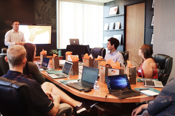 People in a group consultation in a conference room.