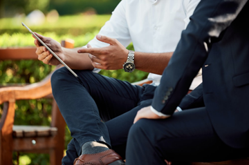 People in a solo consultation on a bench.
